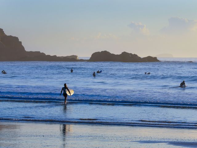 a woman heading to Jetty Beach, Coffs Harbour