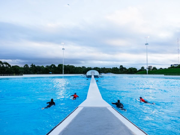 surfers in the wave pool at URBNSURF Sydney