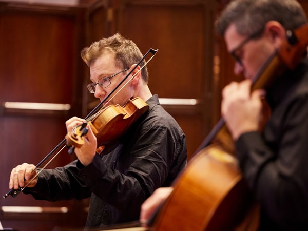 members of the Adelaide Symphony Orchestra playing the violin