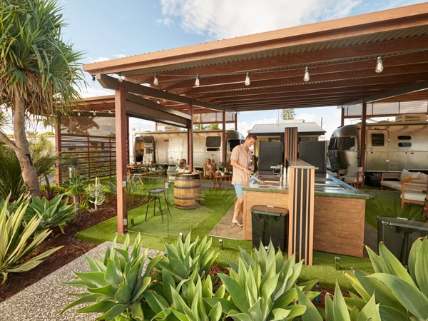 a man preparing at the outdoor kitchen of Brisbane Holiday Village