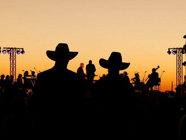 silouettes of crowd and performers at Festival of Outback Opera Singing In The Night event 2024