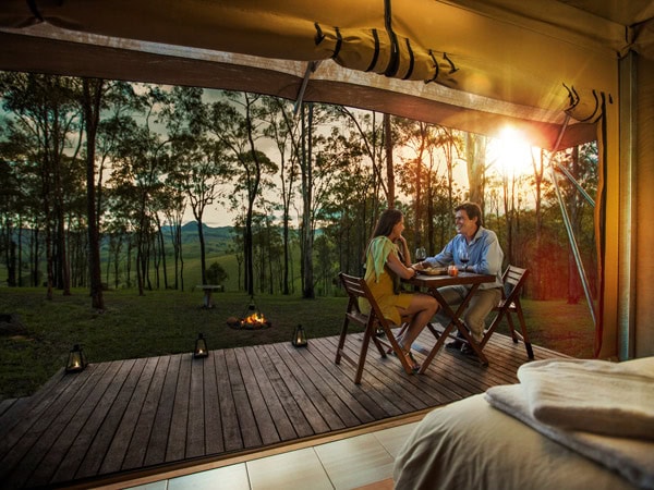 a couple relaxing at a luxury eco tent in Ketchup’s Bank Glamping, Scenic Rim