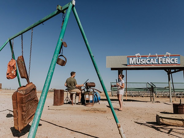 people playing on winton's musical fence and found percussion