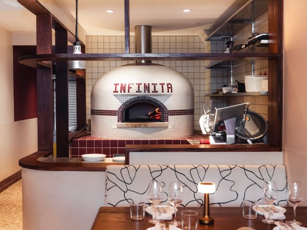 a cosy bar with a fireplace at Bar Infinita, Gordon