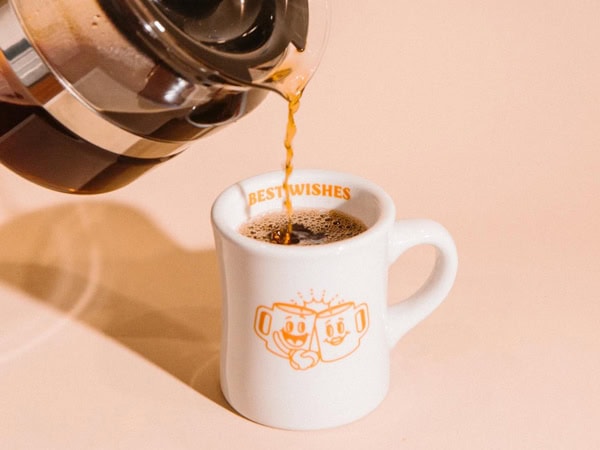pouring coffee into a cup at Best Wishes cafe in Fremantle