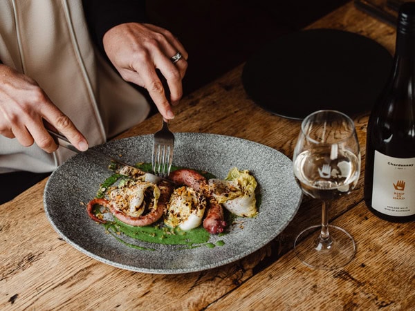 a plate of food with wine at Bird in Hand