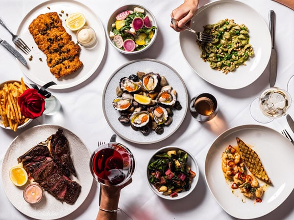 a spread of dinner plates on the table at Bottega Wine Bar