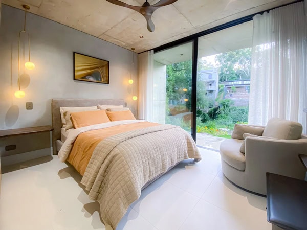 a modern bedroom with floor-to-ceiling windows