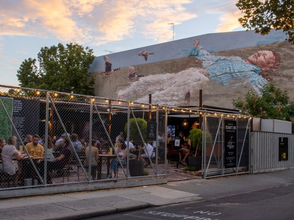 guests enjoying a drink at the courtyard of Calamity's Rod brewery in Fremantle