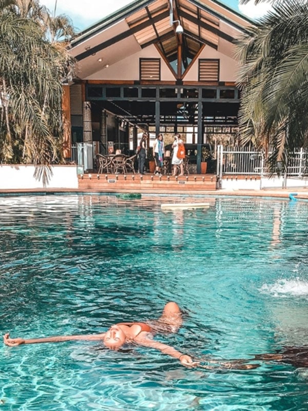 a woman floating by the pool at Darwin Airport Resort