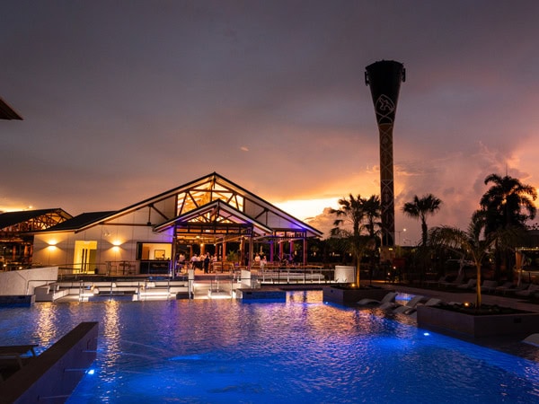 the view of the pool at night in Darwin Airport Resort