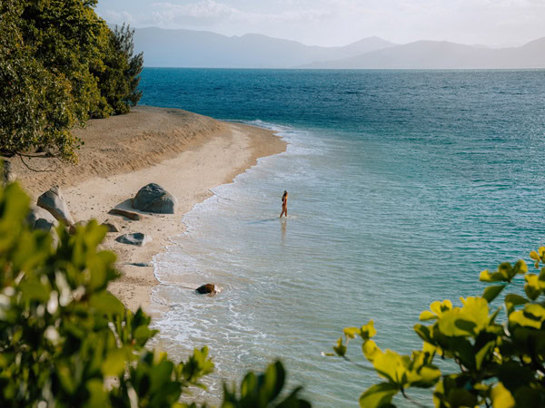 a woman dipping in Nudey Beach on Fitzroy Island