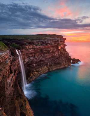 a scenic view of Curracurrong Falls at sunset