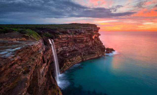 a scenic view of Curracurrong Falls at sunset