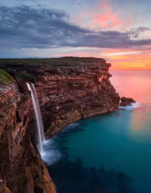 a scenic view of Curracurrong Falls at sunset