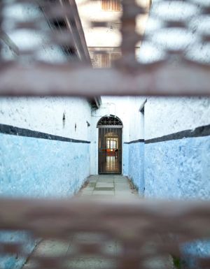 peeking through a small hole in the corridor of Fremantle Prison