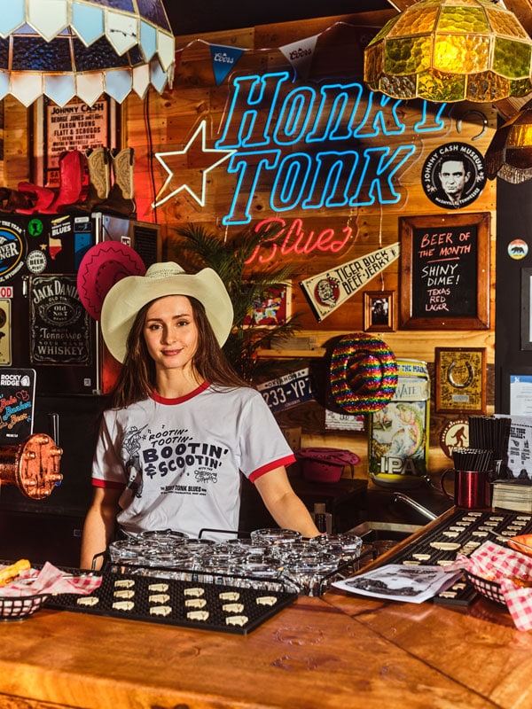 a girl wearing a Mexican hat at the bar counter of Honky Tonk