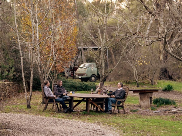 friends sitting outside while enjoying drinks at Jeanneret Wines