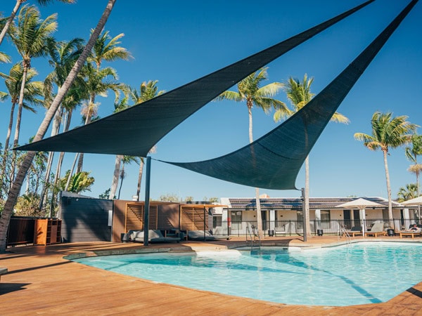 the Karratha International Hotel Pool surrounded by palm trees