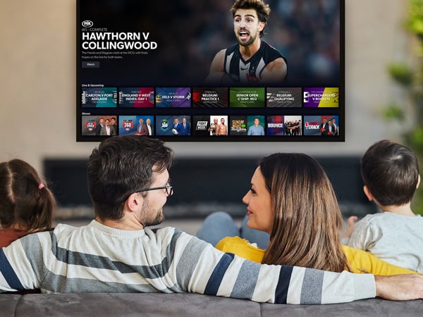 a family watching TV on the Kayo Sports app