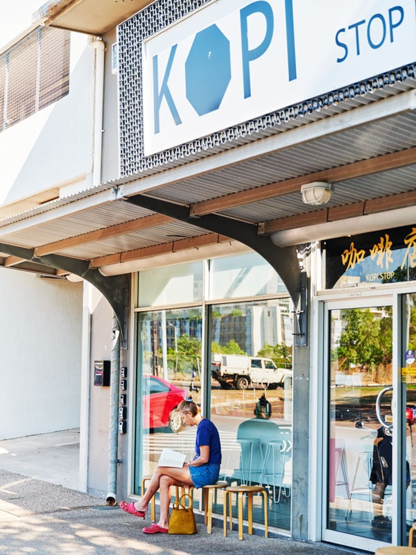 a man sitting outside Kopi Stop, Darwin