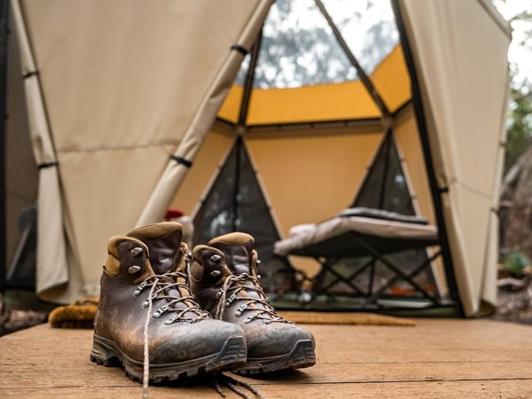 hiking boots outside a tent