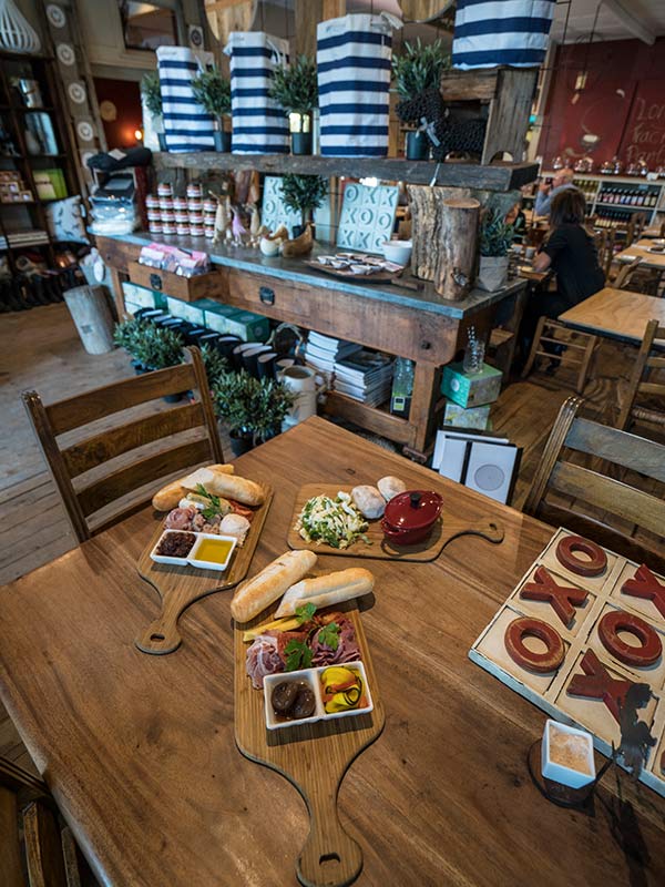 table spread of food with front counter in Long Track Pantry shop and cafe