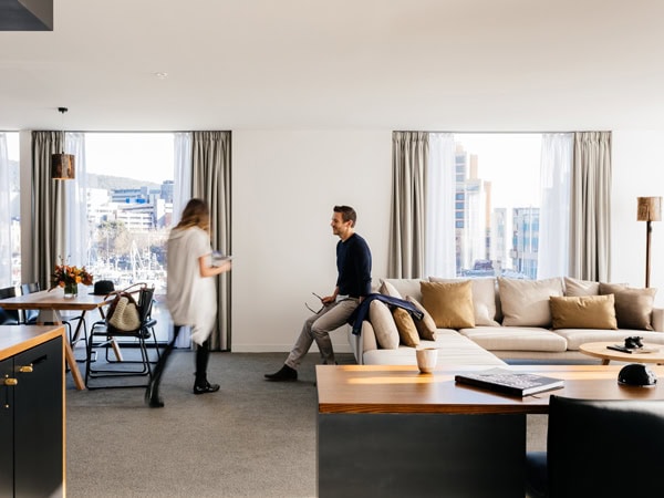 a couple relaxing in one of the rooms in MACq01, Hobart