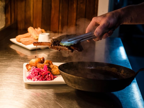 transferring pork belly from a pan