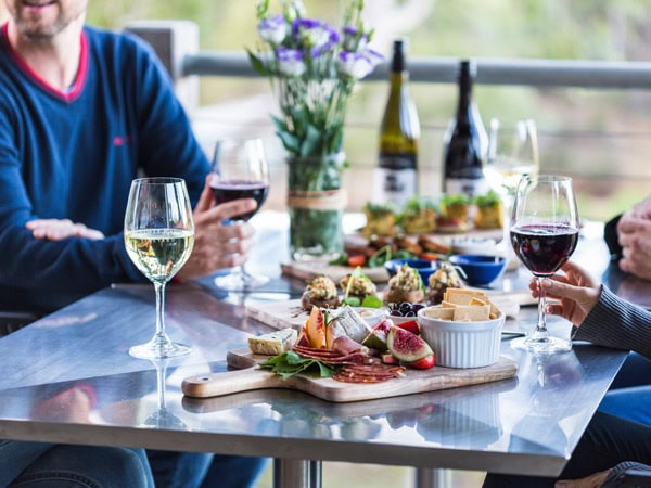 friends enjoying a wine tasting platter with wines