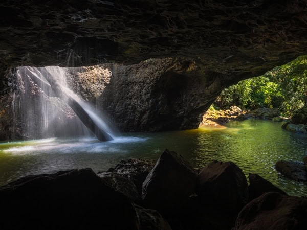 water cascading down a hidden cave in Natural Bridge, Qld