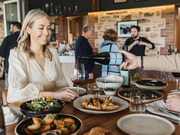 a woman enjoying her wine-tasting meals at O’Leary Walker Wines
