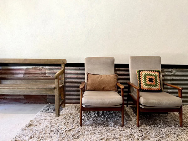 cushioned chairs and a wooden bench at Old Brickworks, Lobethal