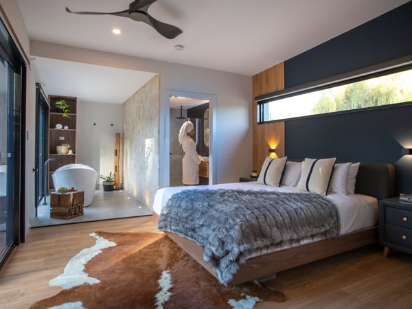 a woman in her robe inside the bedroom at Pavilions at Lenswood