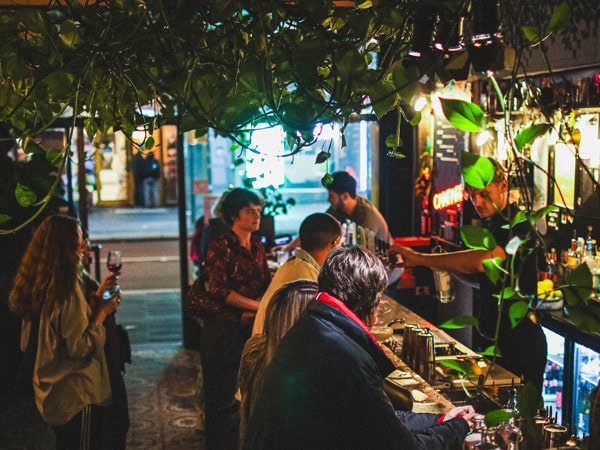 people sitting inside a dimly bar at Ronnie Nights