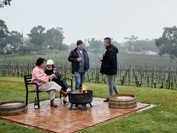 friends relaxing at Simon Tolley by the fire on a rainy afternoon