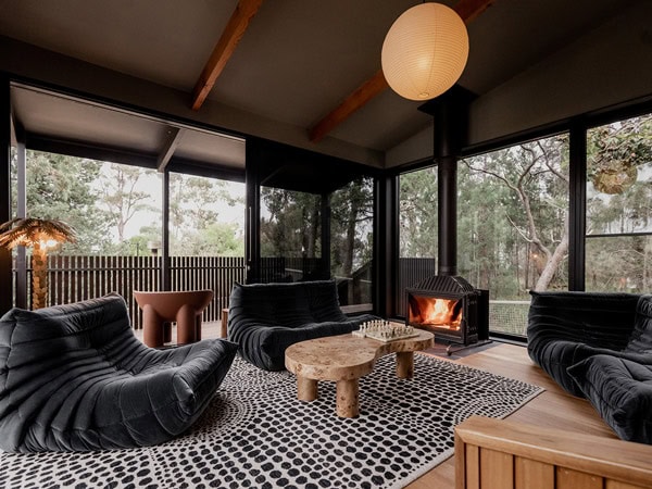 a living room with a fireplace at Sisters, Tas