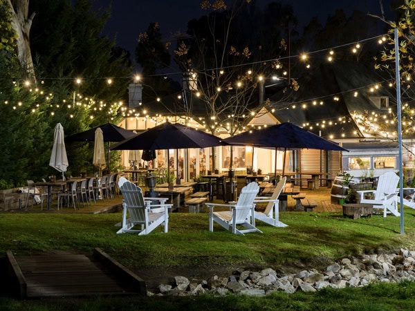 an al fresco dining setup with fairy lights at Stanley Bridge Tavern