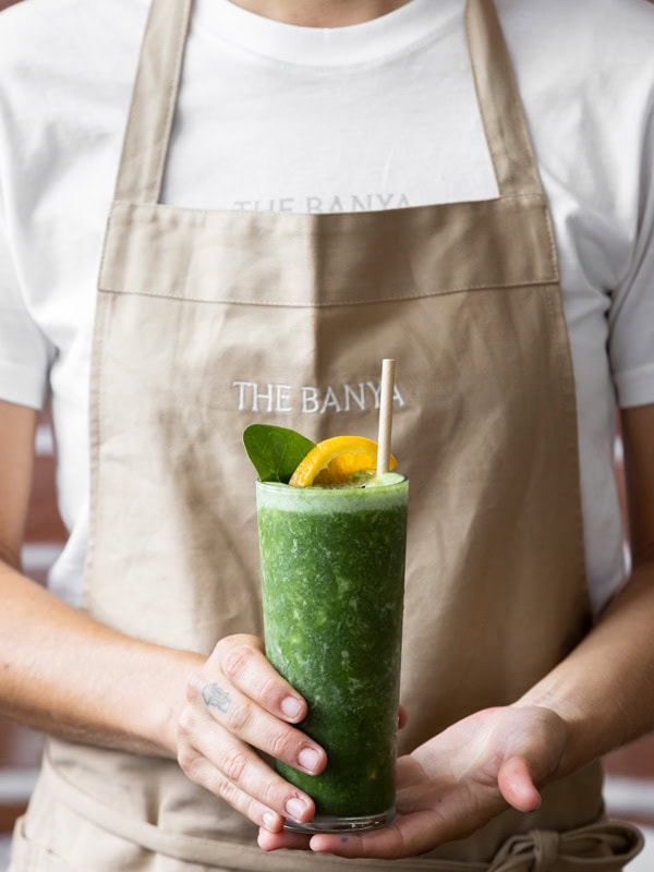 holding a green drink at The Banya