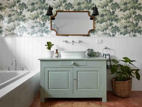 a pastel green bathroom interior with a mirror at Lakehouse Retreat