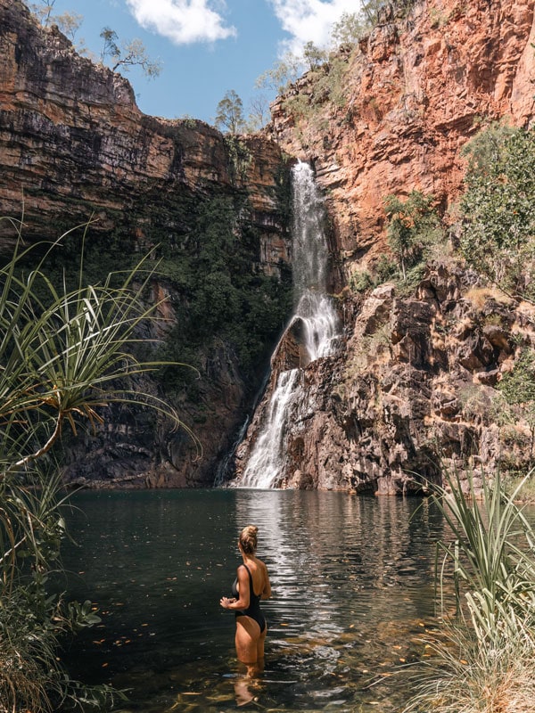 a woman dipping in the basin of Tjaynera Falls