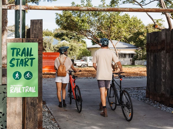 two cyclists entering the Tweed section start of the rail trail