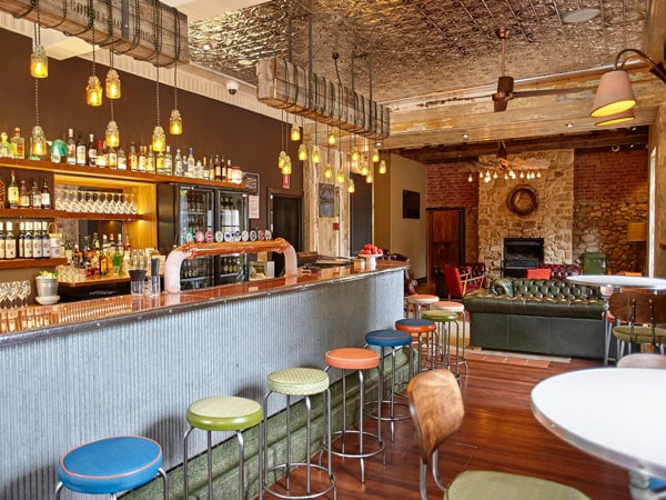 the vibrant restaurant interior of Uraidla Hotel with colourful stools