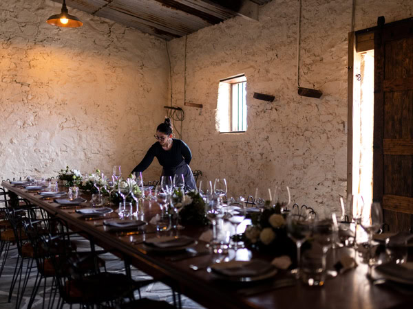 a staff arranging the dining table at Watervale Hotel 