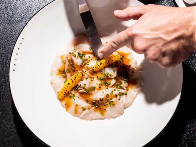 a hand preparing a dish at Pascale Bar & Grill, Melbourne