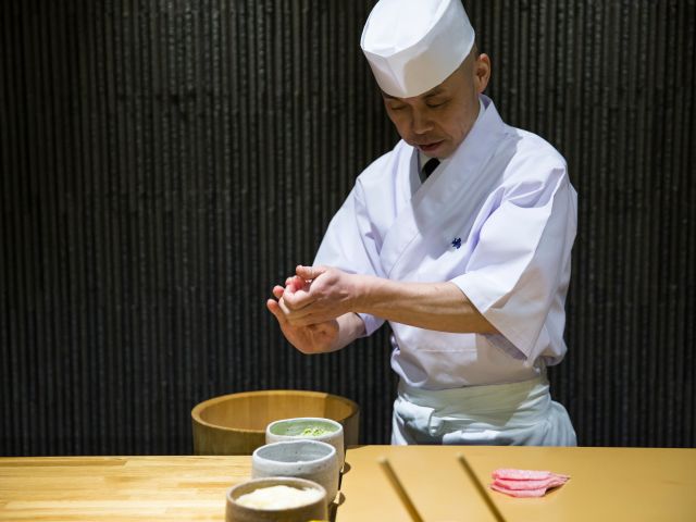 Sushi master Koichi Minamishima preparing food