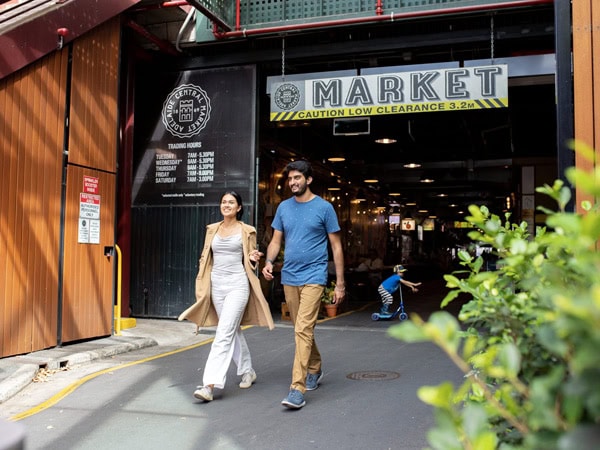 a couple walking out of the Adelaide Central Market