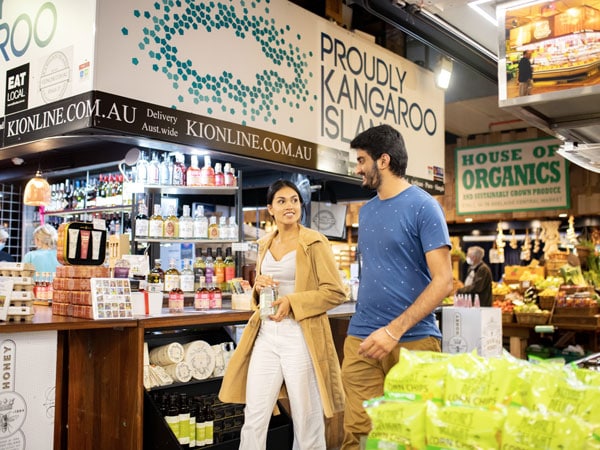 a couple walking around Adelaide Central Market near Kangaroo Island Shop