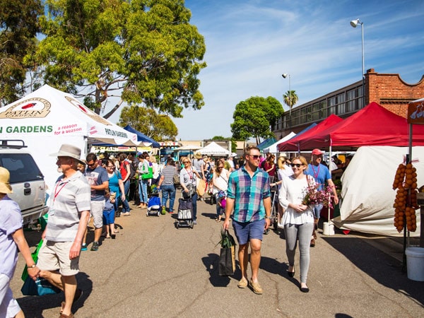 a couple strolling around the stalls at Adelaide Farmers Market