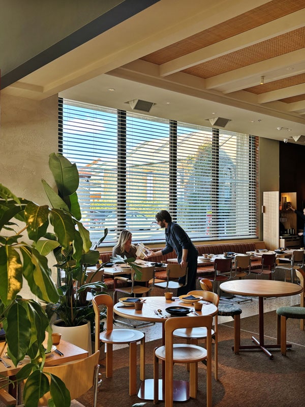 a waiter arranging the chairs at the BANG restaurant, The StandardX Melbourne